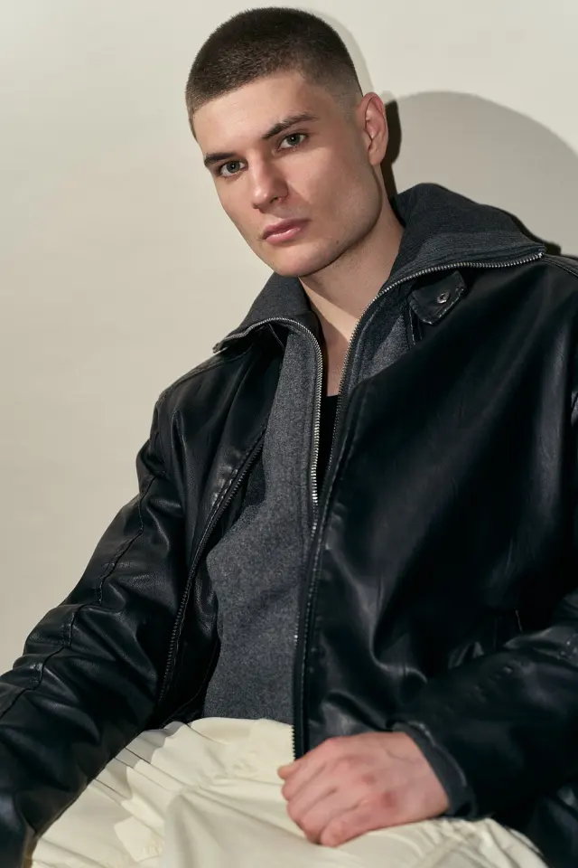 Lutfi Al Fathi seated in a black leather jacket